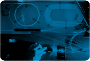 Optical Engines technician working with fiber laser components in a photonics lab